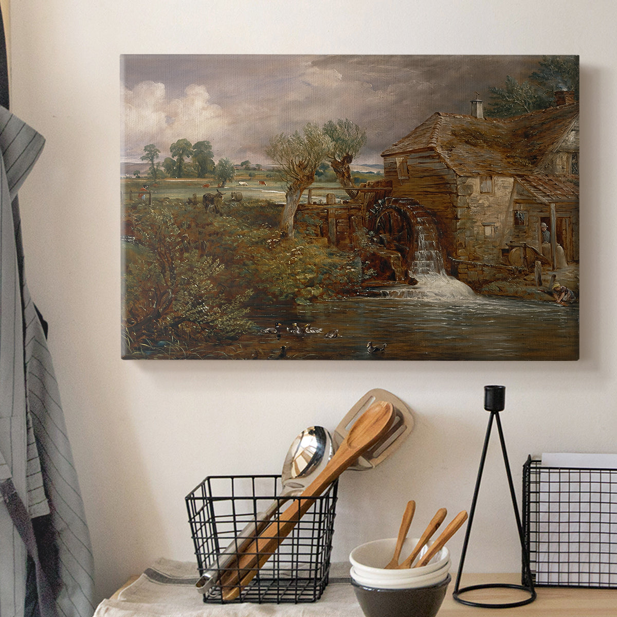 Canvas art print detailing a pastoral view featuring mill, displayed in a softly lit workspace setting