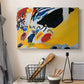 Canvas art print detailing an abstract depiction of concert atmosphere using color emphasis, displayed in a softly lit workspace setting