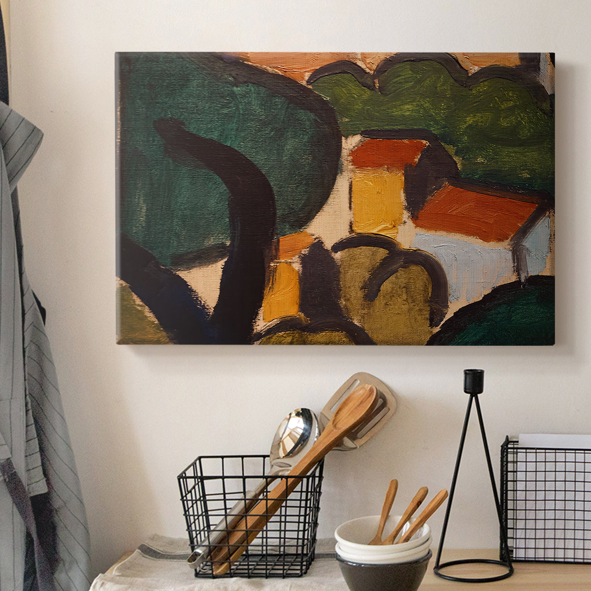 Canvas art print detailing an expressive composition of buildings and vegetation, displayed in a softly lit workspace setting