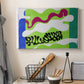 Canvas art print detailing a stylized cut-out design evoking water, displayed in a softly lit workspace setting
