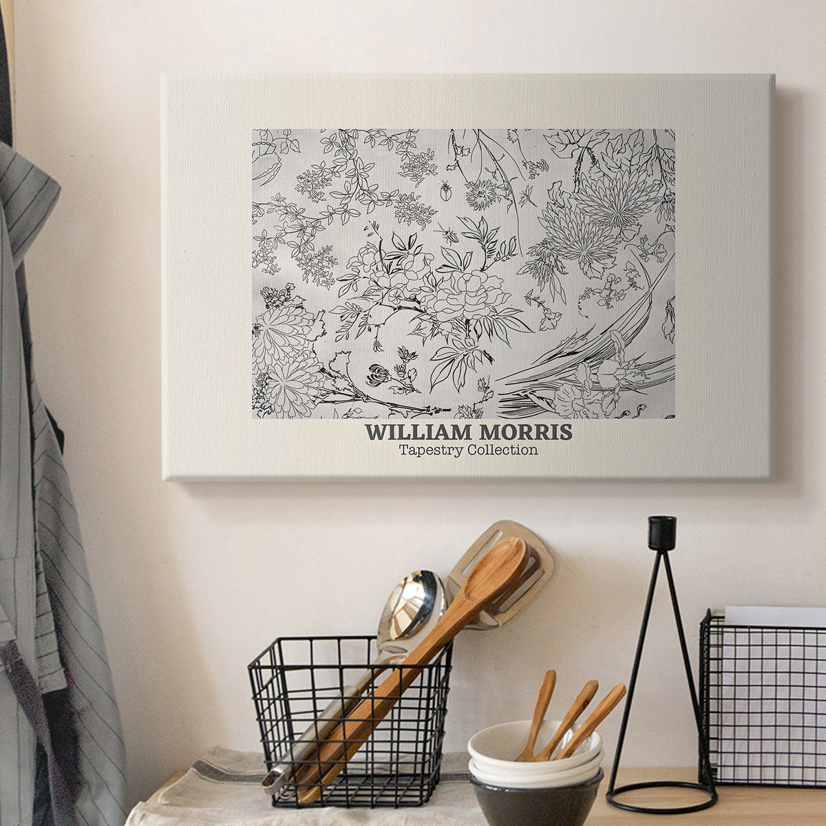 Canvas art print detailing a textile-style floral composition with repeating motifs, displayed in a softly lit workspace setting