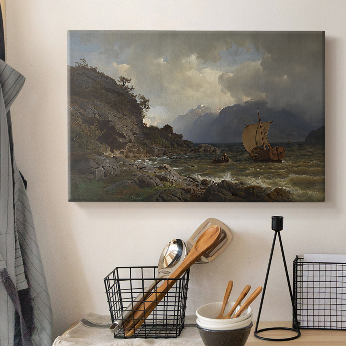 Canvas art print detailing a Nordic coastal scene with waves and distant vessels, displayed in a softly lit workspace setting