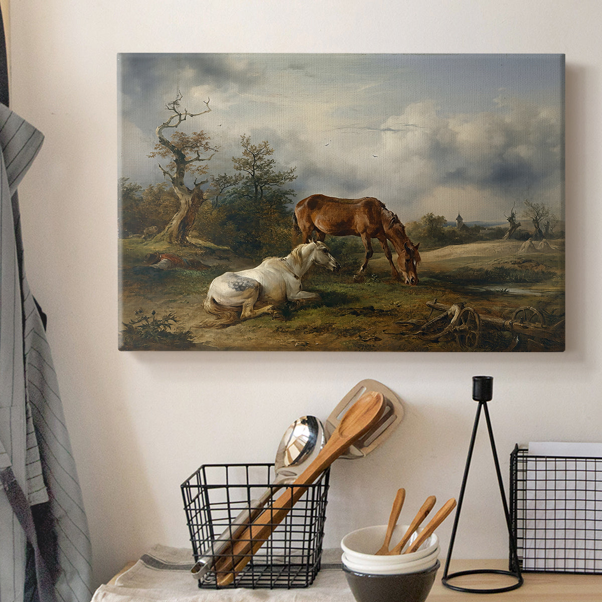 Canvas art print detailing a countryside composition with grazing animals, displayed in a softly lit workspace setting