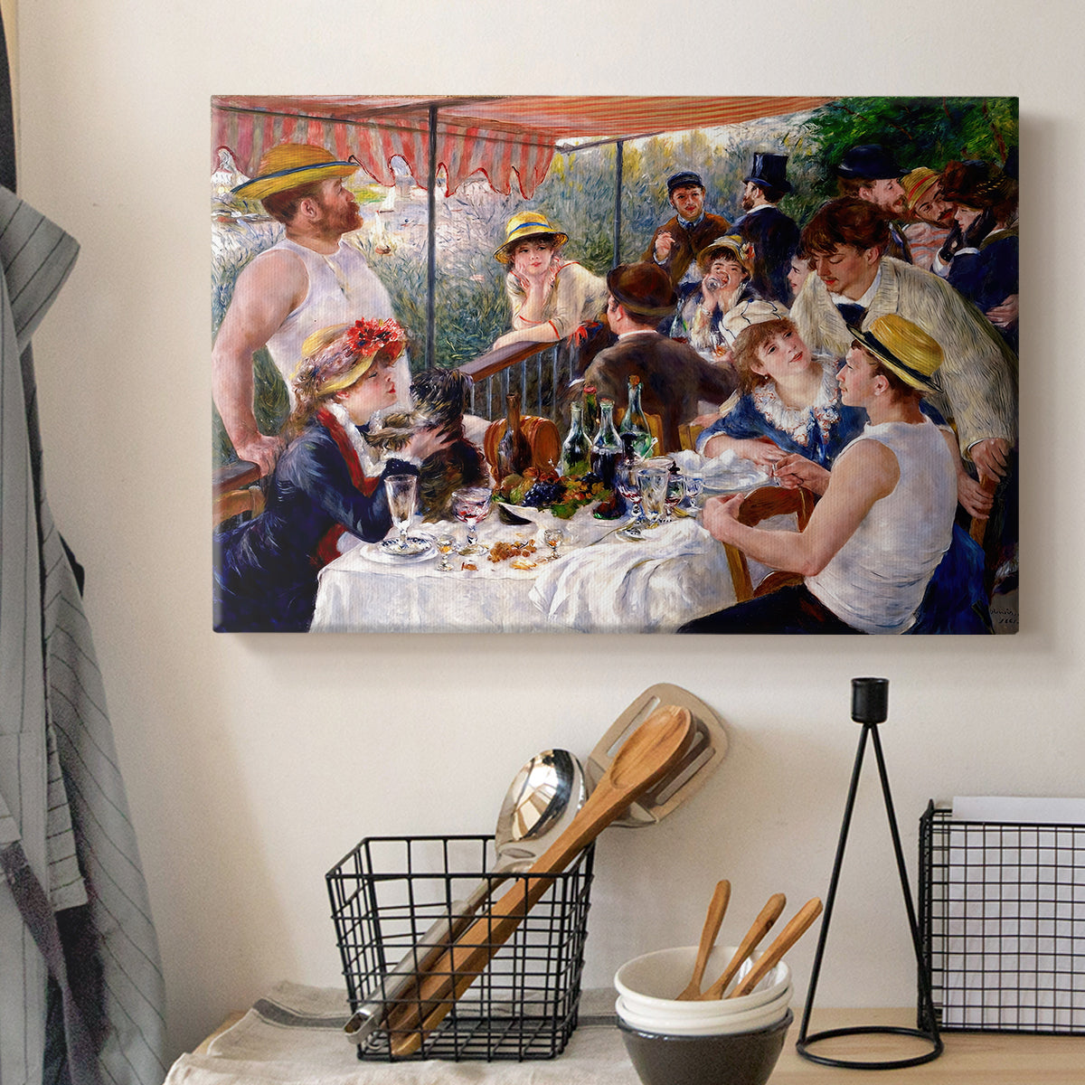 Canvas art print detailing a social dining scene with figures seated around table on riverside terrace, displayed in a softly lit workspace setting