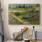 Canvas art print detailing a stylized landscape featuring plants and pathways, displayed in a softly lit workspace setting