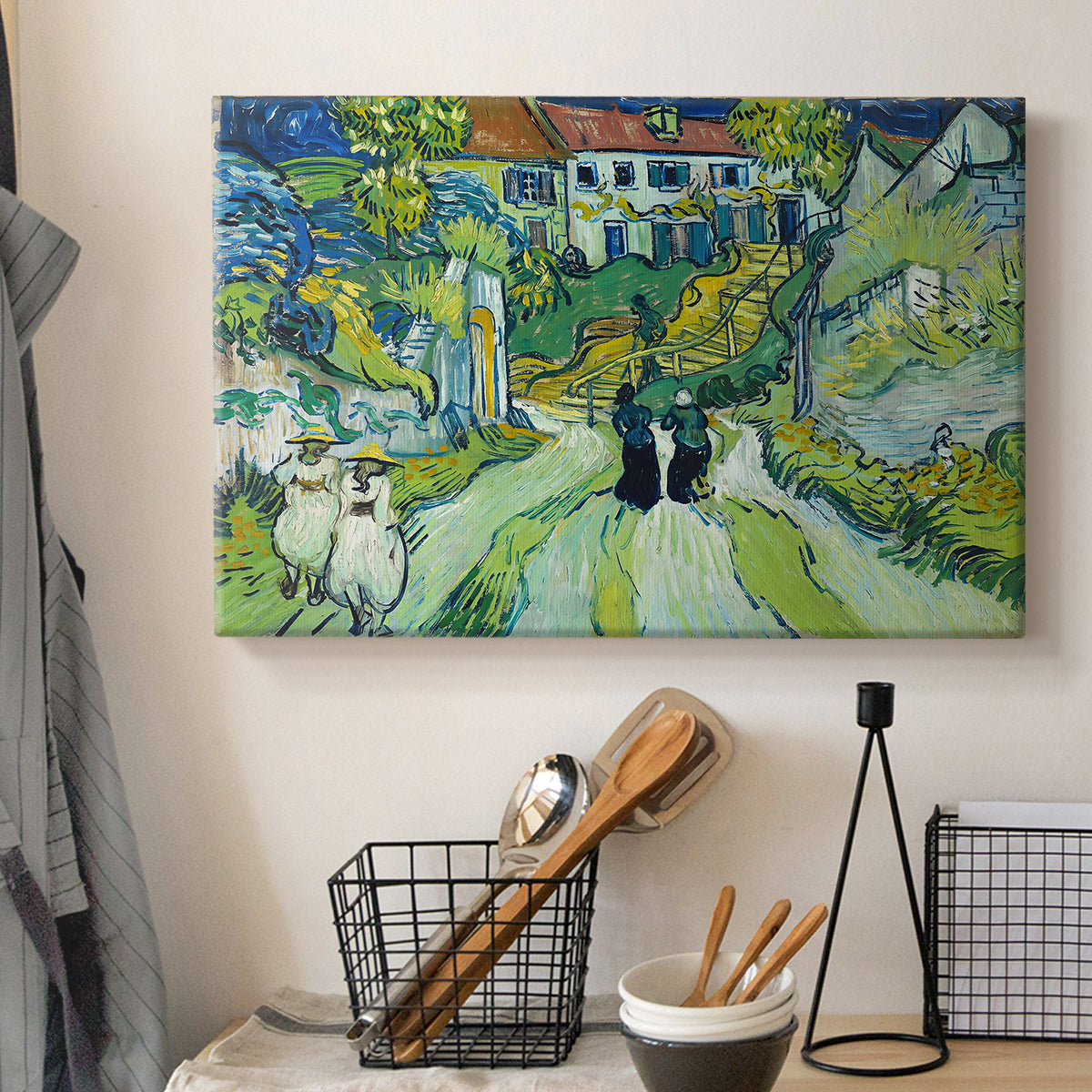 Canvas art print detailing a stylized cityscape with stairway and houses, displayed in a softly lit workspace setting