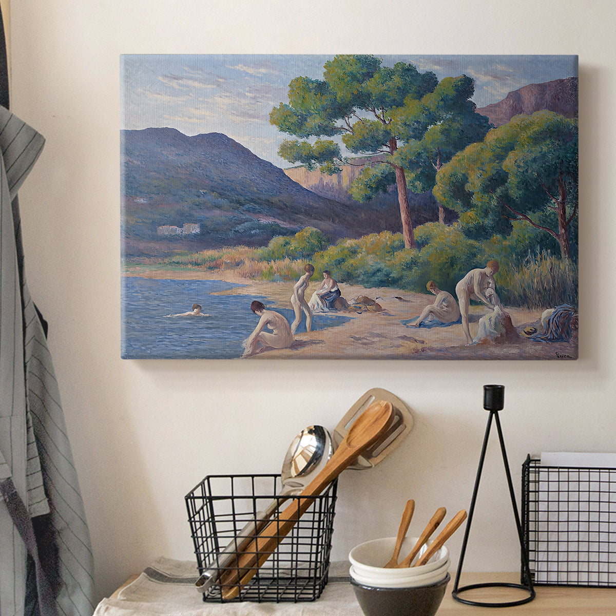 Canvas art print detailing a seaside scene with bathers, displayed in a softly lit workspace setting