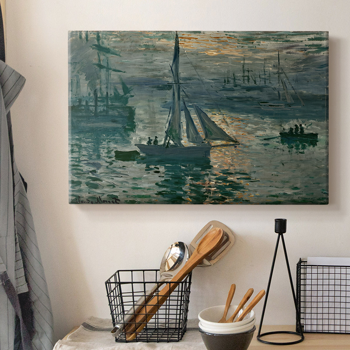 Canvas art print detailing an atmospheric ocean view with sun rising through haze, displayed in a softly lit workspace setting