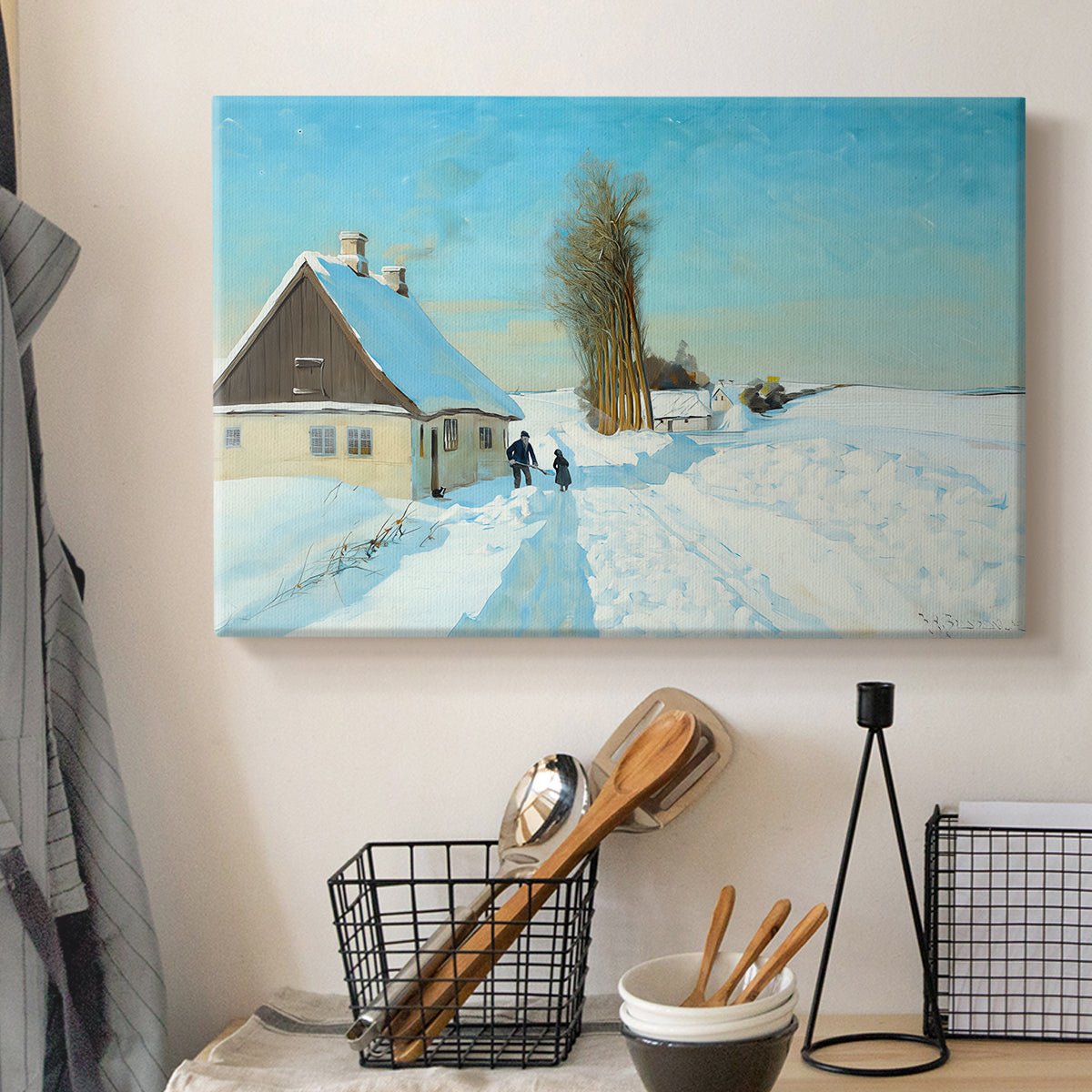 Canvas art print detailing a rural home setting with snow-covered ground and activity, displayed in a softly lit workspace setting
