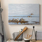 Canvas art print detailing a flock of geese positioned along marshy terrain, displayed in a softly lit workspace setting
