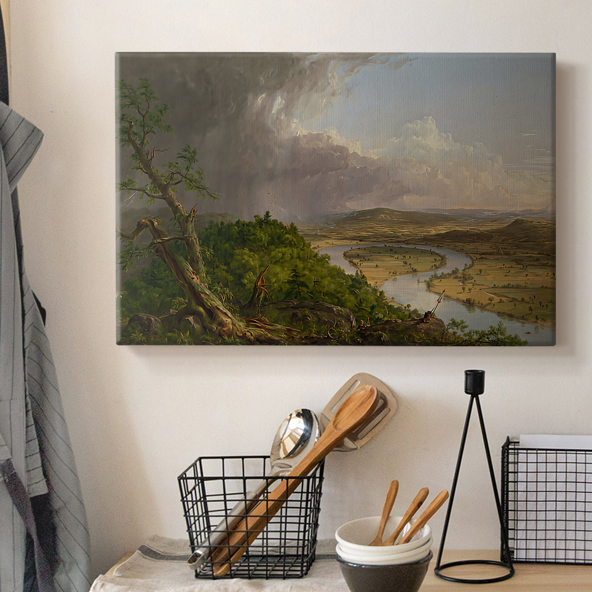 Canvas art print detailing an iconic composition with river bend and contrasting skies, displayed in a softly lit workspace setting