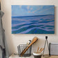 Canvas art print detailing a stylized coastal scene with layered horizontal composition, displayed in a softly lit workspace setting