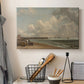 Canvas art print detailing a maritime landscape with shoreline, displayed in a softly lit workspace setting
