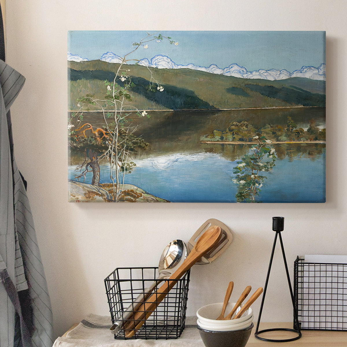 Canvas art print detailing an atmospheric landscape emphasizing turbulent sky over calm terrain, displayed in a softly lit workspace setting
