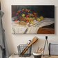 Canvas art print detailing a tabletop composition with fruit and subtle shadows, displayed in a softly lit workspace setting