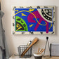 Canvas art print detailing a stylized arrangement of horse and human forms, displayed in a softly lit workspace setting