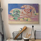 Canvas art print detailing a stylized figure study with decorative color blocks, displayed in a softly lit workspace setting