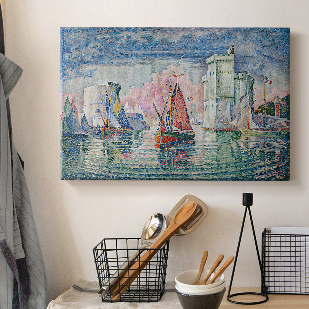 Canvas art print detailing a maritime landscape with harbor, displayed in a softly lit workspace setting