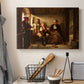 Canvas art print detailing a realistic depiction of peasants gathered in a rustic home setting, displayed in a softly lit workspace setting