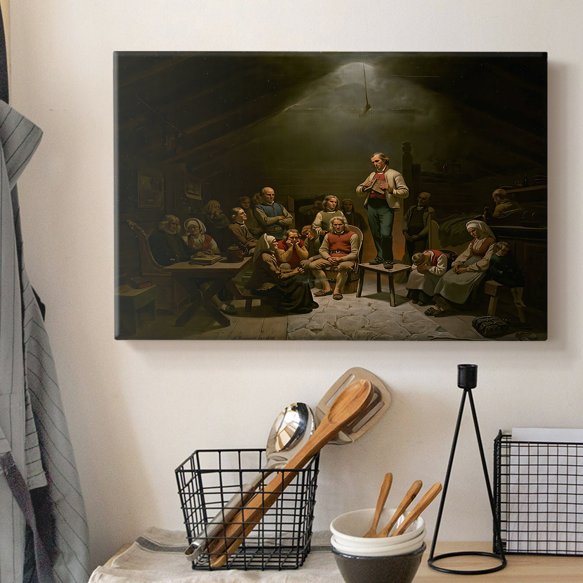 Canvas art print detailing a traditional devotional scene of community worship inside farmhouse, displayed in a softly lit workspace setting