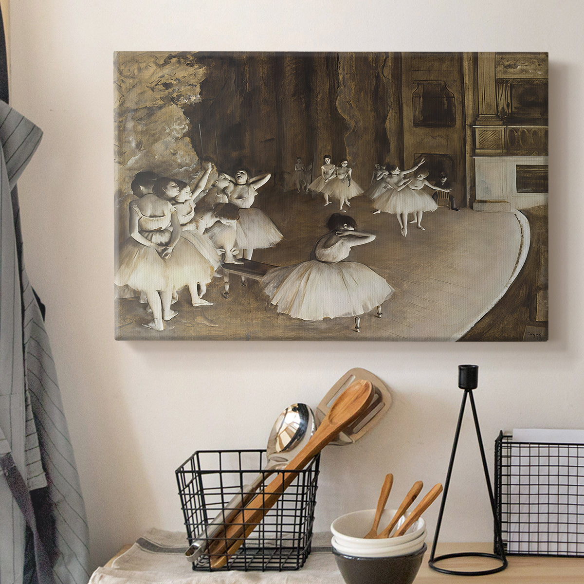 Canvas art print detailing dancers arranged on stage with visible set and depth, displayed in a softly lit workspace setting