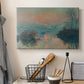 Canvas art print detailing an atmospheric landscape combining cold tones and warm sky, displayed in a softly lit workspace setting