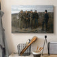 Canvas art print detailing an outdoor group scene centered on military interaction, displayed in a softly lit workspace setting