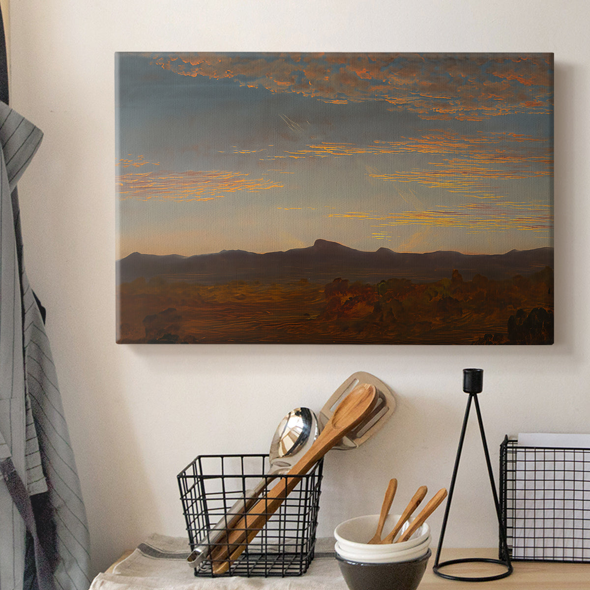 Canvas art print detailing a panoramic natural view with low mountains and open plain, displayed in a softly lit workspace setting