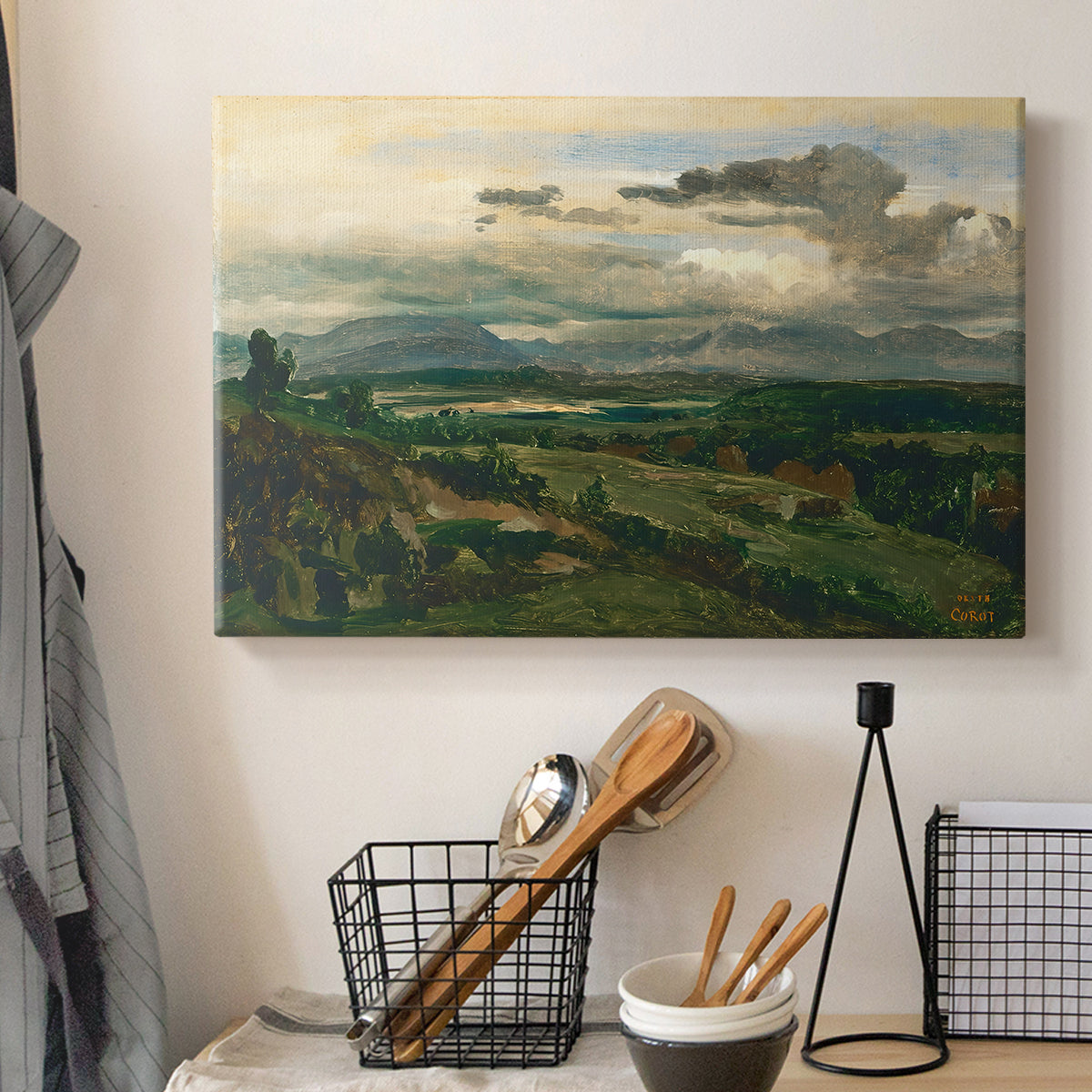 Canvas art print detailing a tranquil scene combining town and natural surroundings, displayed in a softly lit workspace setting