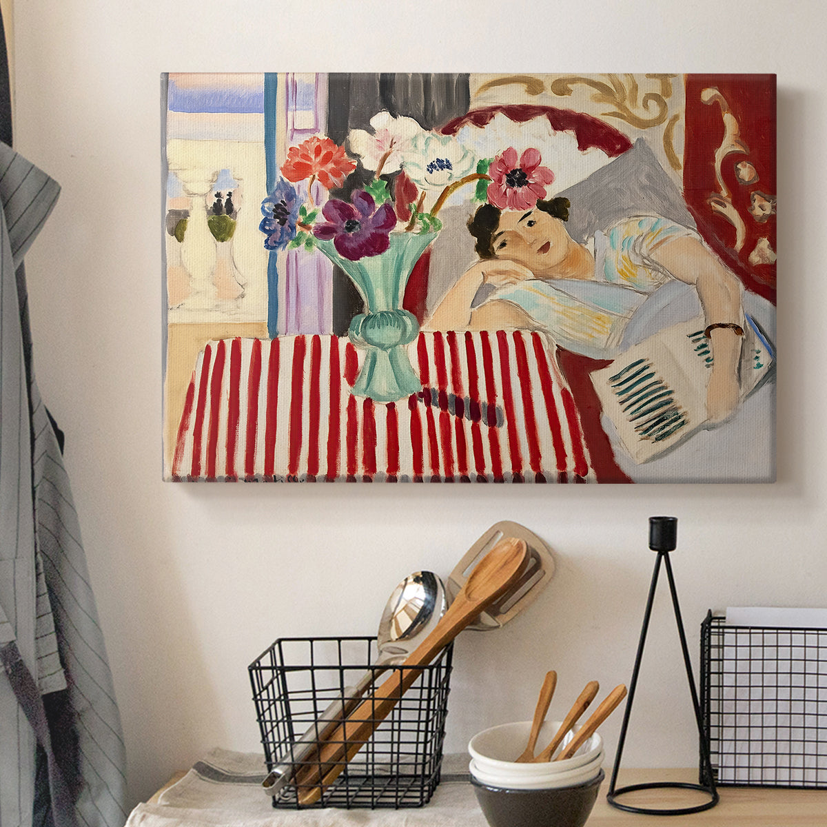 Canvas art print detailing a stylized composition with figure and decorative textiles, displayed in a softly lit workspace setting