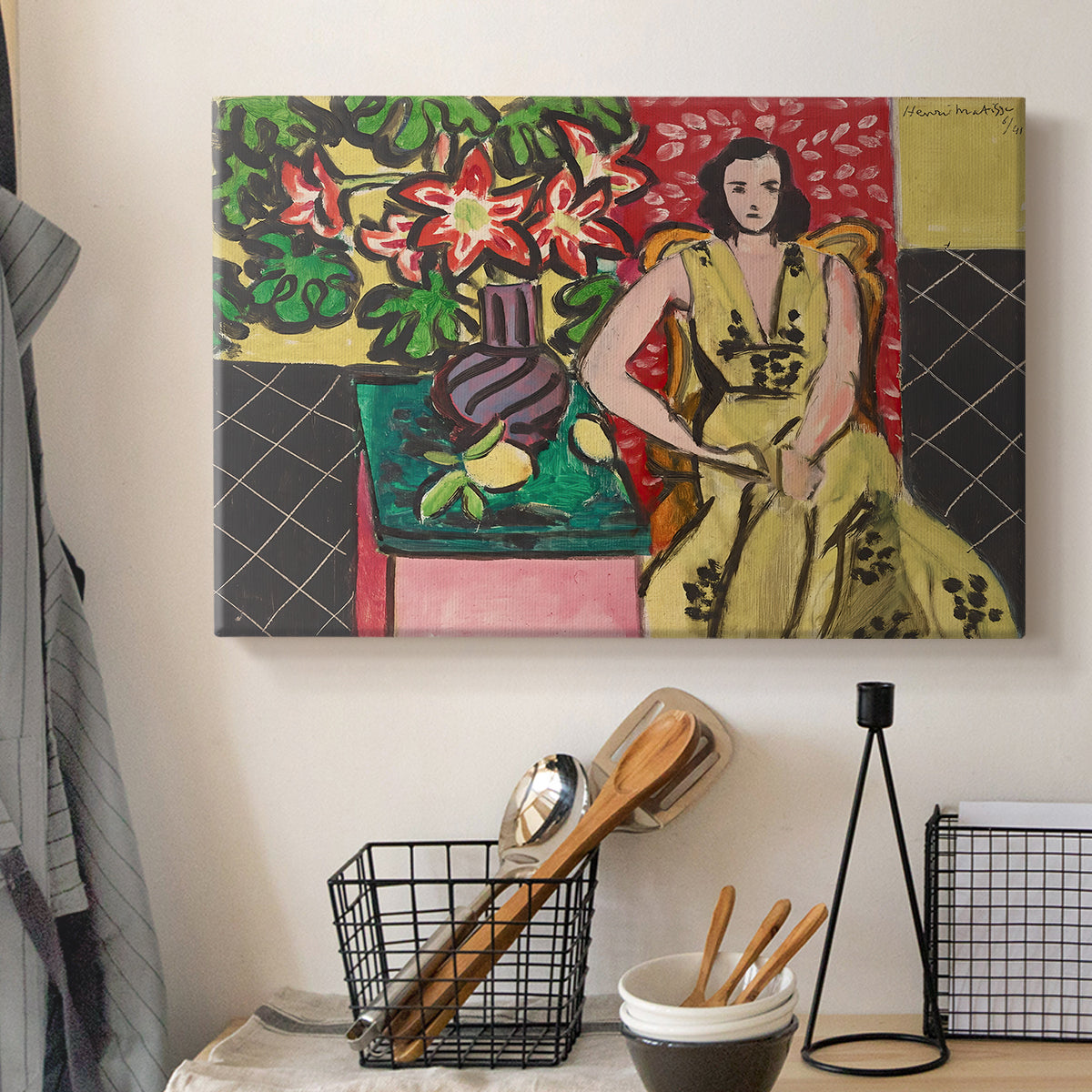 Canvas art print detailing a stylized composition of a woman next to a flower vase, displayed in a softly lit workspace setting