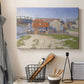 Canvas art print detailing an urban composition with structures, displayed in a softly lit workspace setting