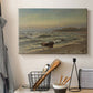 Canvas art print detailing a dramatic coastal weather scene with churning waves, displayed in a softly lit workspace setting