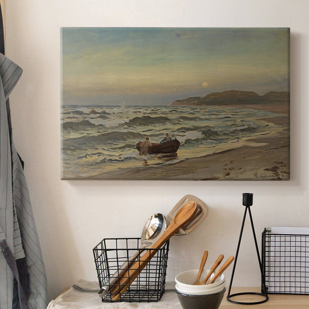 Canvas art print detailing a dramatic coastal weather scene with churning waves, displayed in a softly lit workspace setting