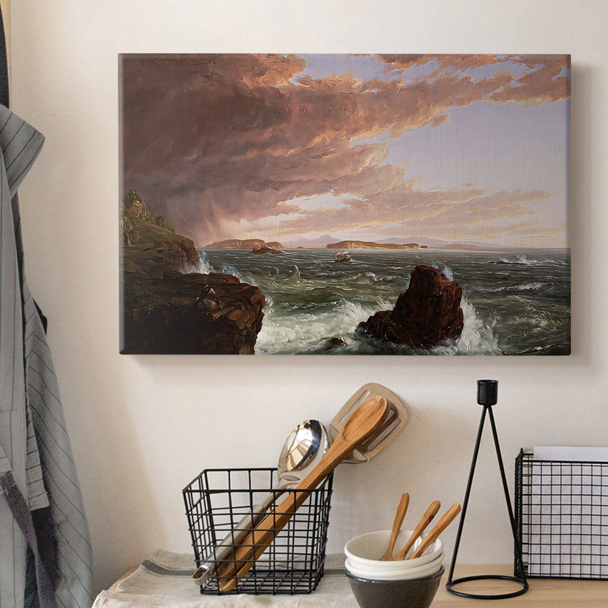 Canvas art print detailing an expansive seascape with light breaking through clouds, displayed in a softly lit workspace setting