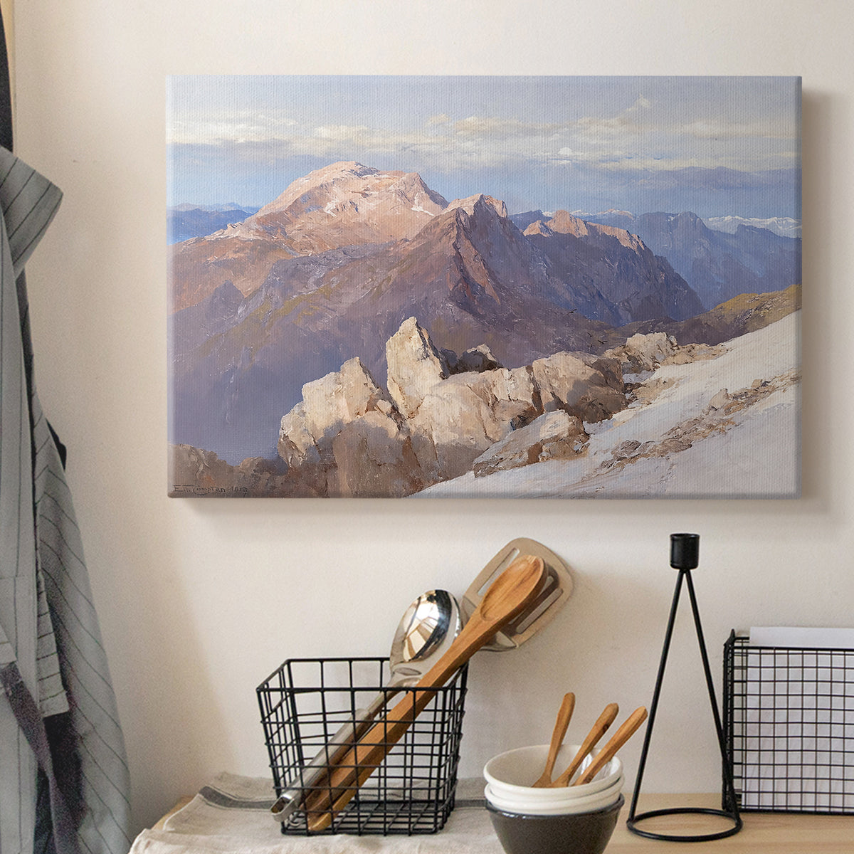 Canvas art print detailing an expansive mountainous landscape with natural depth, displayed in a softly lit workspace setting
