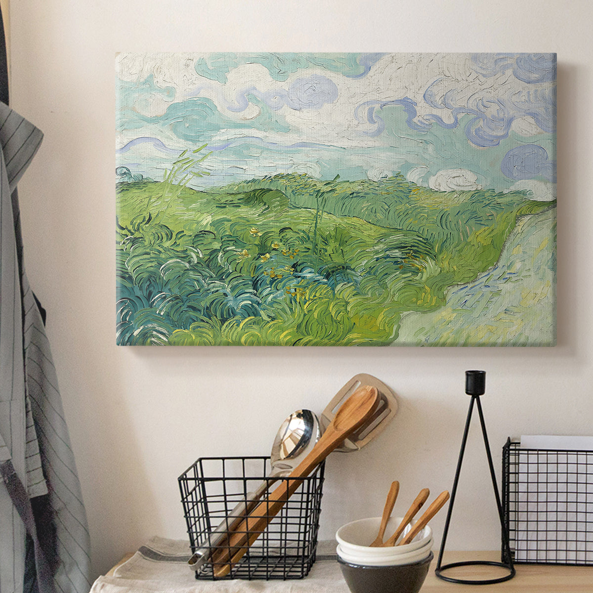 Canvas art print detailing a rural field view with textured brushwork and distant slopes, displayed in a softly lit workspace setting