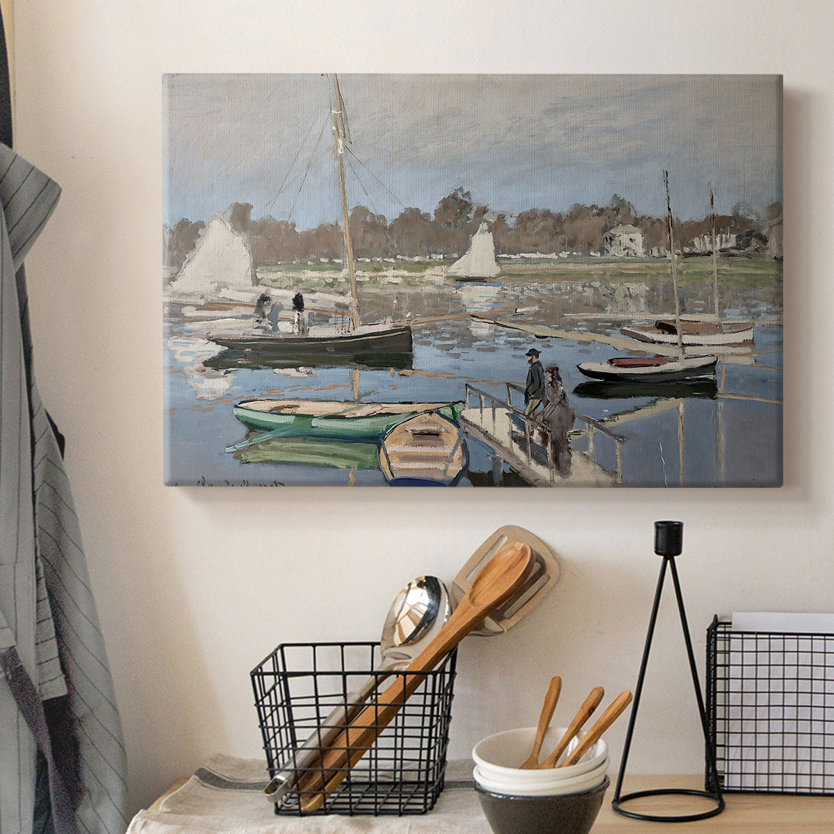 Canvas art print detailing a tranquil river setting with sailboats and shoreline, displayed in a softly lit workspace setting