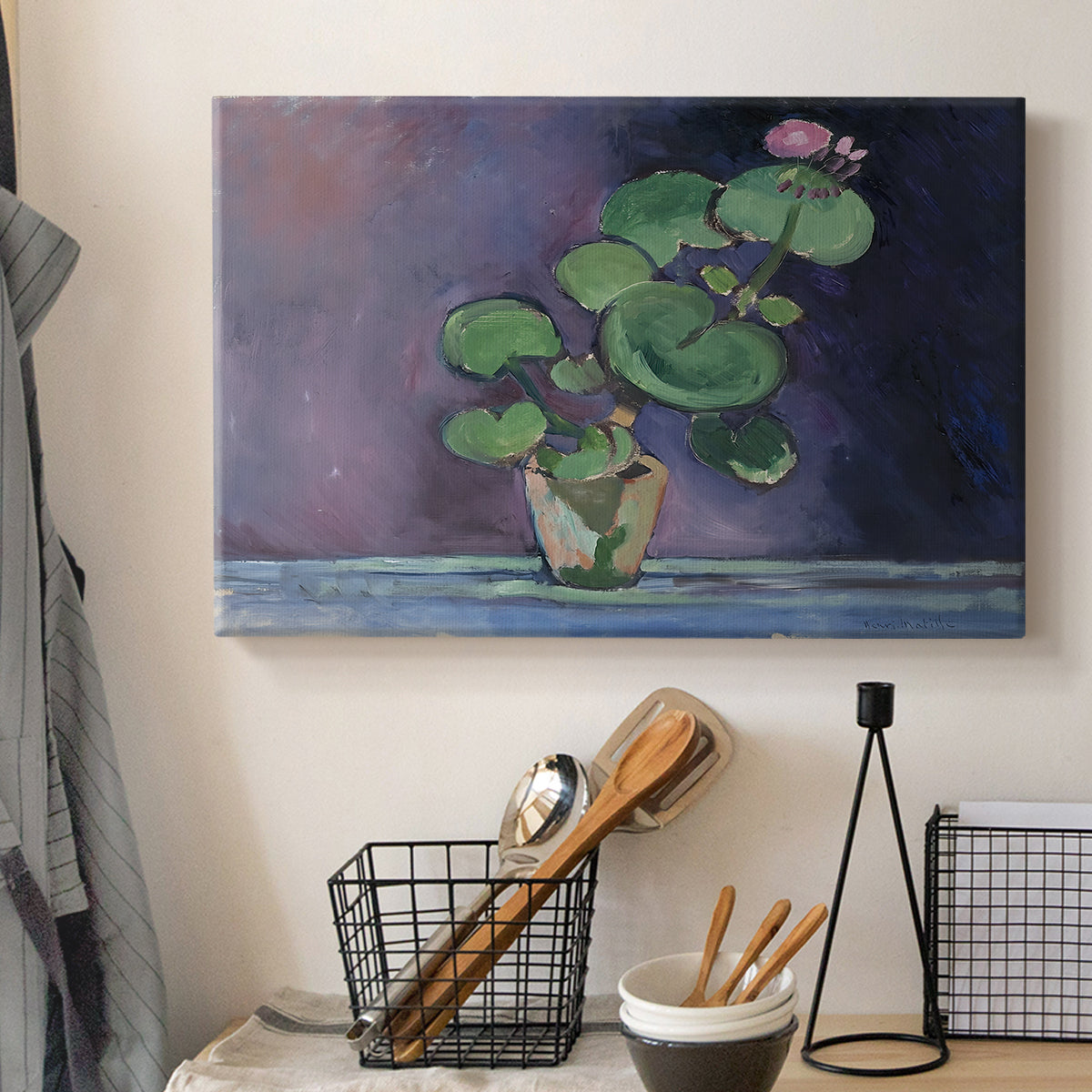 Canvas art print detailing a simple still life featuring a potted geranium, displayed in a softly lit workspace setting