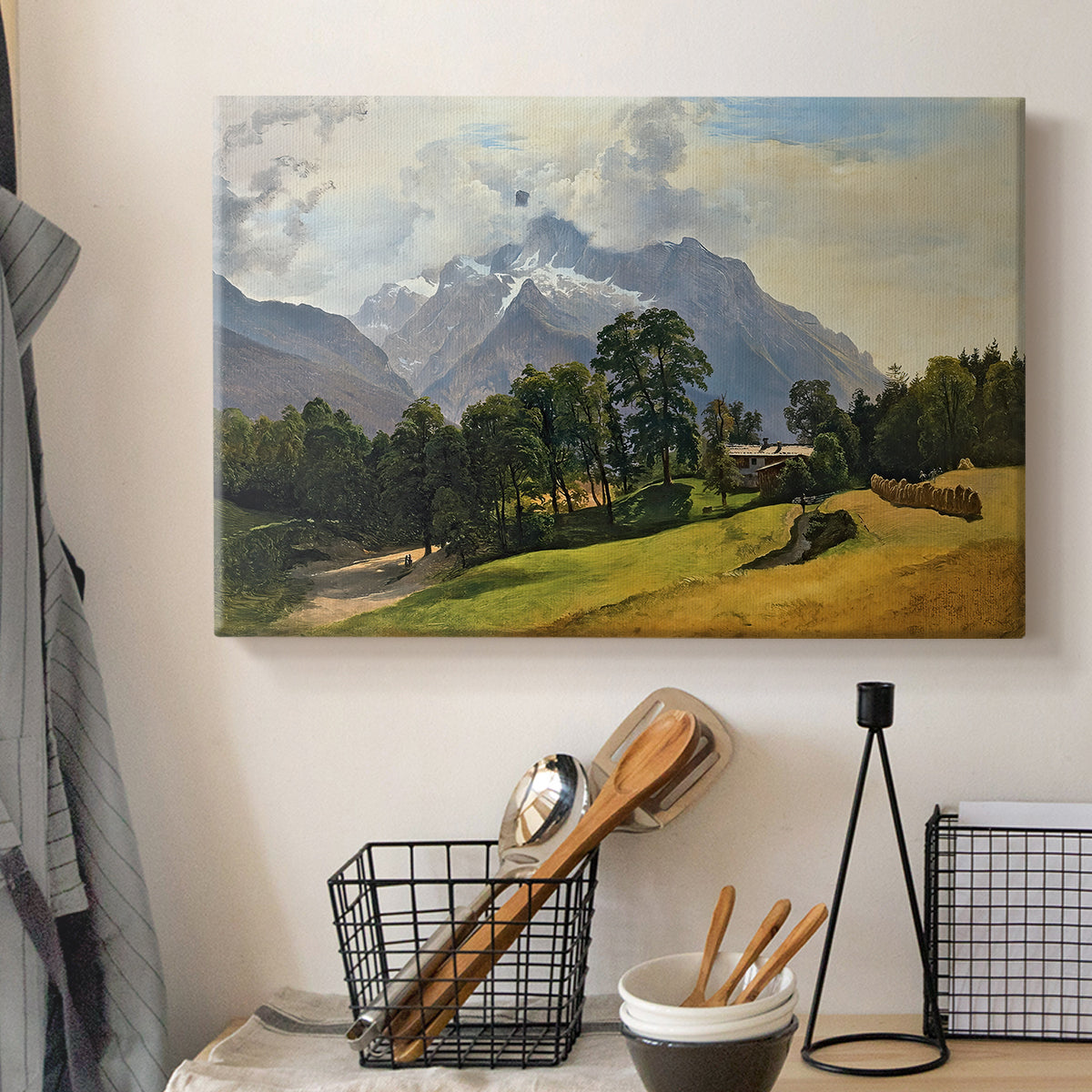 Canvas art print detailing a scenic alpine view with open sky, displayed in a softly lit workspace setting