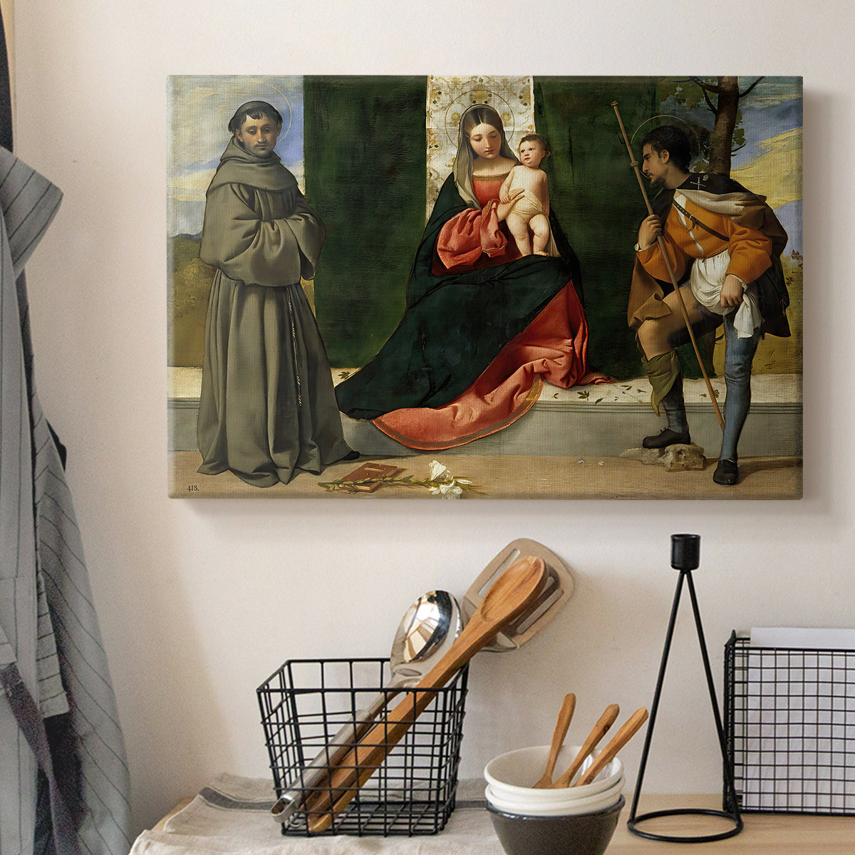 Canvas art print detailing a formal devotional scene with seated Madonna and standing holy figures, displayed in a softly lit workspace setting