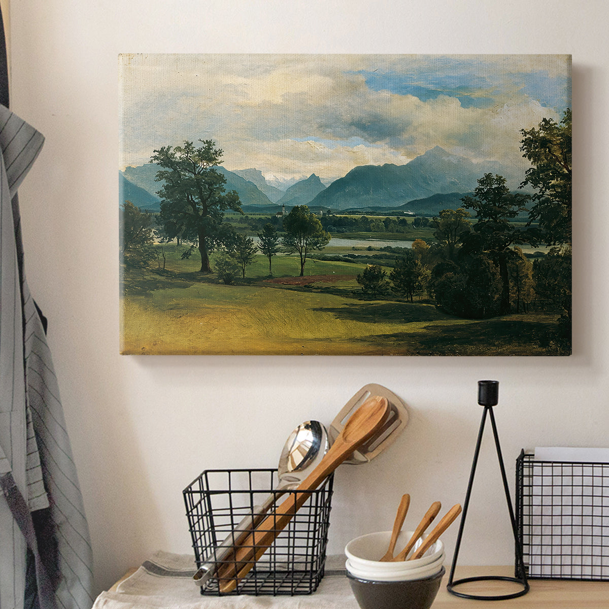 Canvas art print detailing a countryside view with soft atmospheric perspective, displayed in a softly lit workspace setting