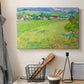 Canvas art print detailing a stylized rural composition with fields and sky, displayed in a softly lit workspace setting