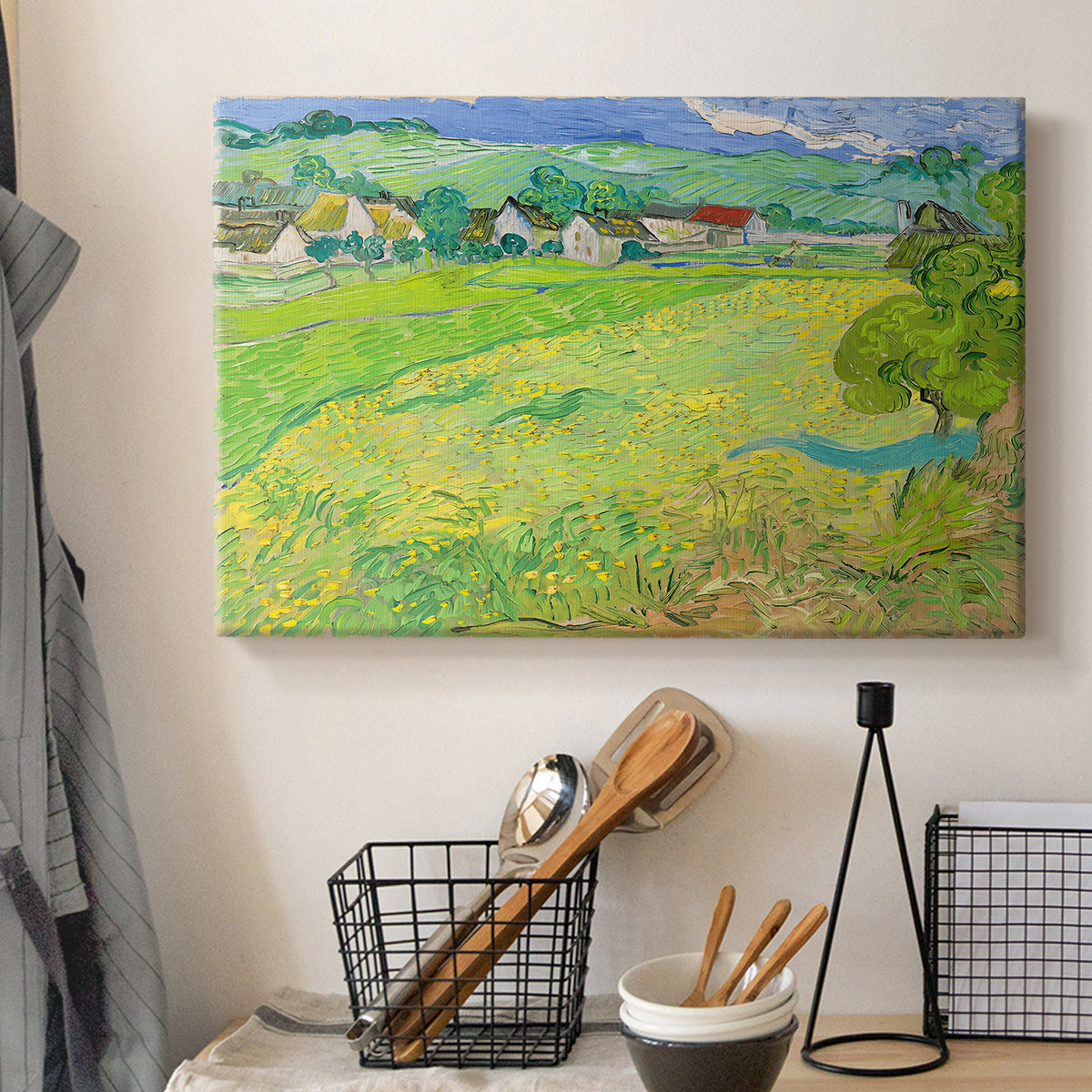 Canvas art print detailing a stylized rural composition with fields and sky, displayed in a softly lit workspace setting