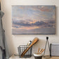 Canvas art print detailing a landscape focused on cloud formations, displayed in a softly lit workspace setting