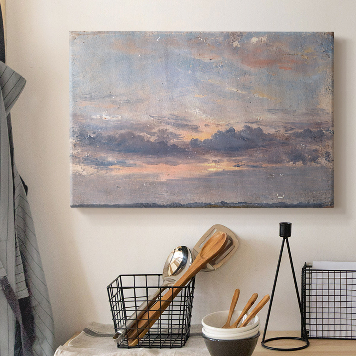 Canvas art print detailing a landscape focused on cloud formations, displayed in a softly lit workspace setting