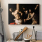 Canvas art print detailing an intense Baroque scene of suffering with strong light and shadow, displayed in a softly lit workspace setting