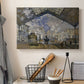 Canvas art print detailing a bustling transport hub with trains beneath glass roof, displayed in a softly lit workspace setting