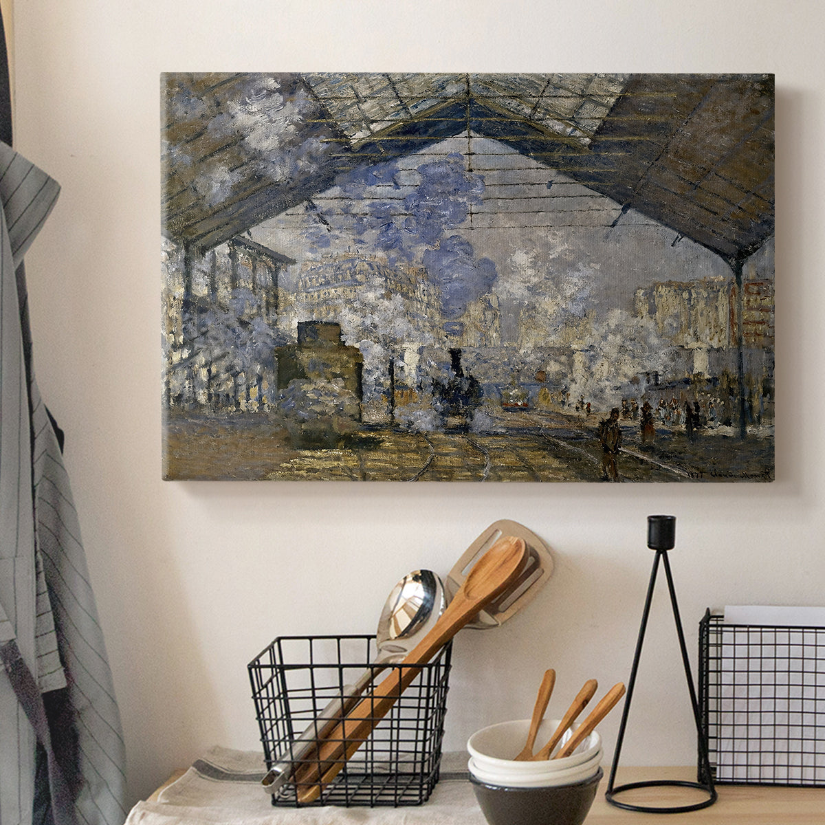 Canvas art print detailing a bustling transport hub with trains beneath glass roof, displayed in a softly lit workspace setting