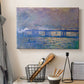 Canvas art print detailing a city bridge scene softened by mist and impressionist brushwork, displayed in a softly lit workspace setting